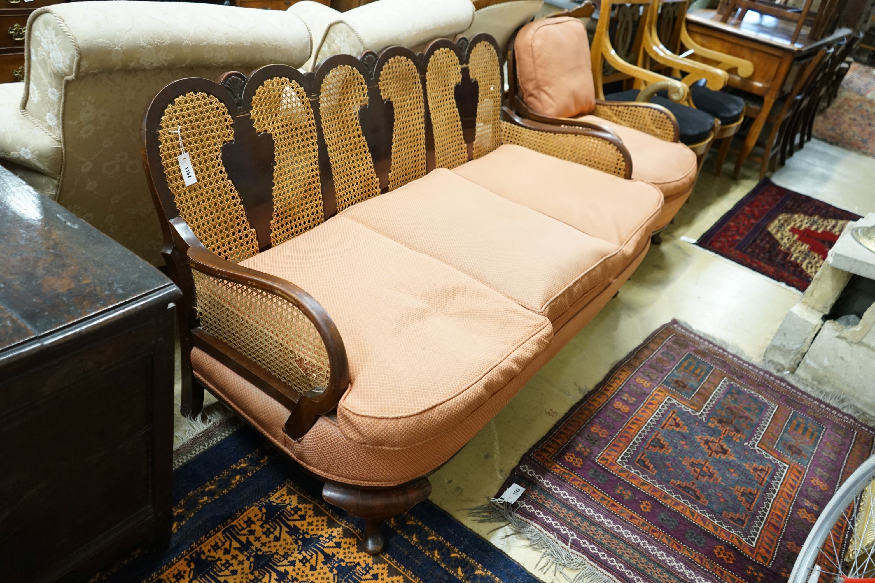 A 1920's caned beech two piece bergere suite, sofa length 167cm, depth 178cm, height 80cm